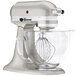 A KitchenAid sugar pearl silver stand mixer with a bowl.