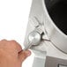 A person using the Hobart FP350-1B food processor to open a silver metal tool.