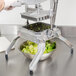A hand using a Nemco 1/2" x 1/2" Blade and Holder Assembly to cut lettuce.