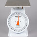 A white Cardinal Detecto mechanical portion scale with a metal surface and a red handle.