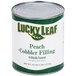 A case of 6 Lucky Leaf #10 cans of peach cobbler filling on a counter.