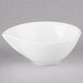 An Arcoroc white porcelain deep bowl with a handle.