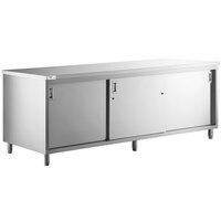 Regency 30 inch x 96 inch 16 Gauge Type 304 Stainless Steel Enclosed Base Table with Sliding Doors and Adjustable Midshelf
