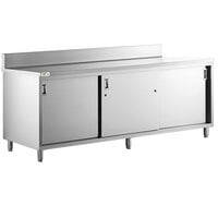 Regency 24" x 96" 16 Gauge Type 304 Stainless Steel Enclosed Base Sliding Door Table with Adjustable Midshelf and 6" Backsplash