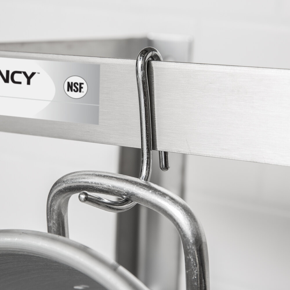 A metal hook is hanging from a stainless steel bar, holding a pot by its handle.