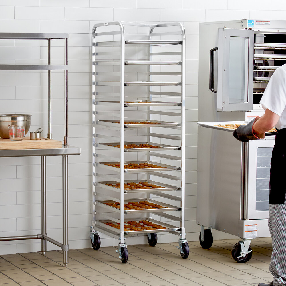A tall, metal rack with multiple shelves holding trays of baked goods, situated in a commercial kitchen setting.