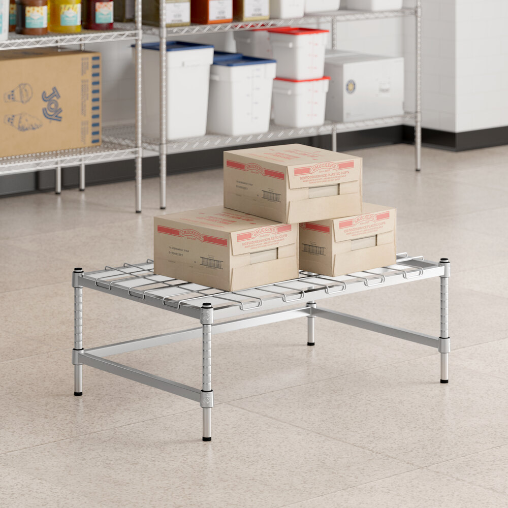 Boxes on a Regency chrome dunnage rack in a room.