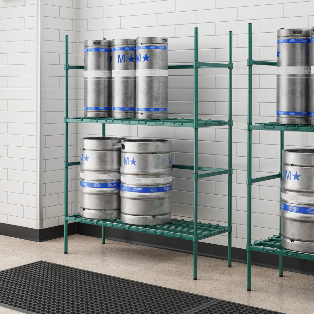 A green metal Regency keg rack in a room with kegs on it.