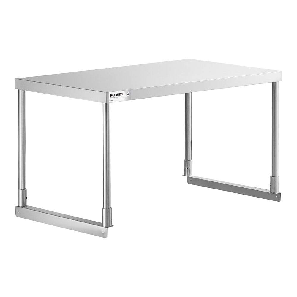 A rectangular stainless steel table with four cylindrical legs and horizontal supports near the base.