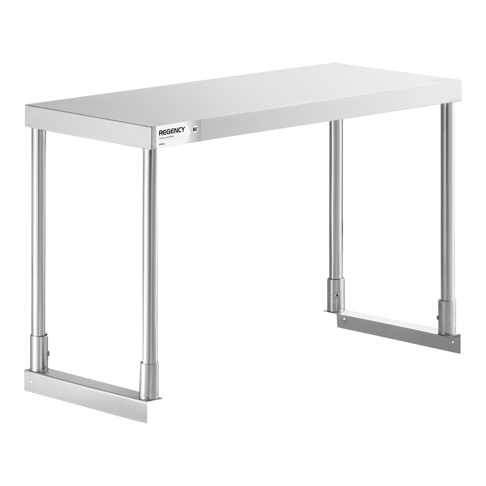 A stainless steel table with four cylindrical legs and a flat rectangular top.