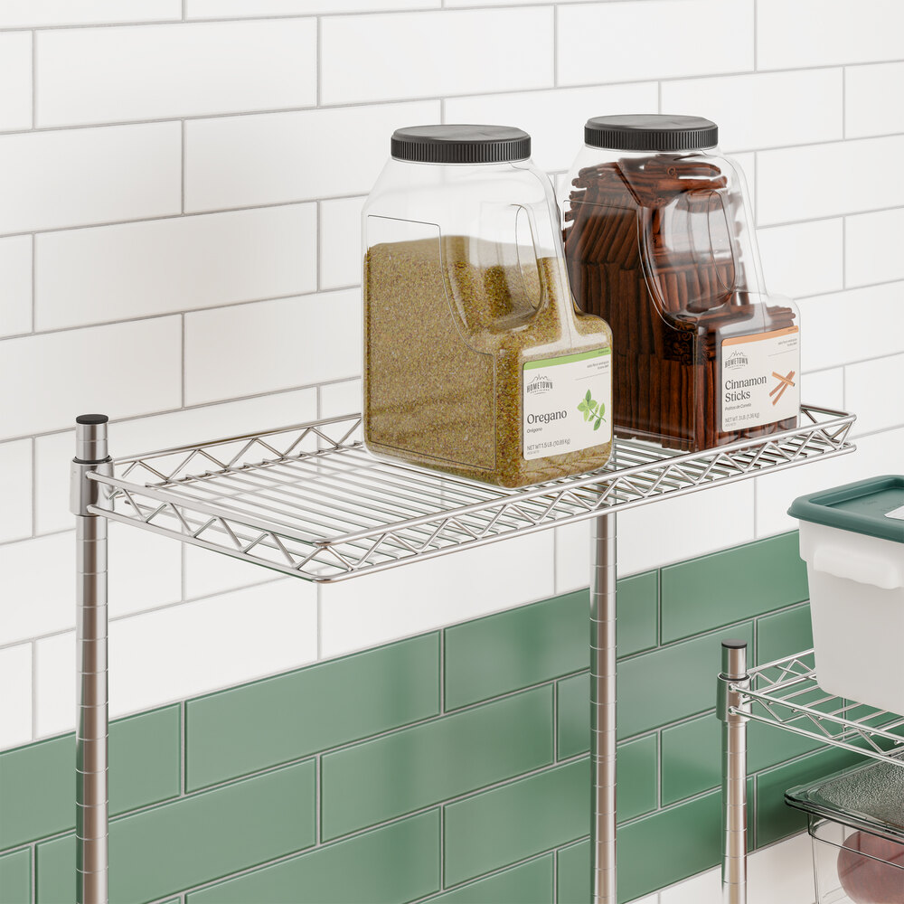 A chrome wire cantilever shelf measuring 12 inches by 24 inches, mounted on a wall with containers placed on top.