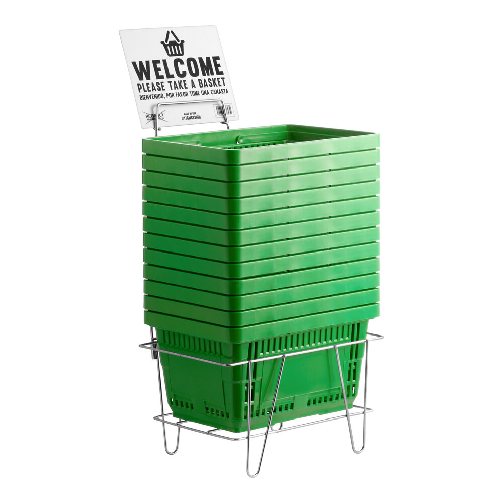 A stack of green plastic grocery shopping baskets with a metal stand and a welcome sign.