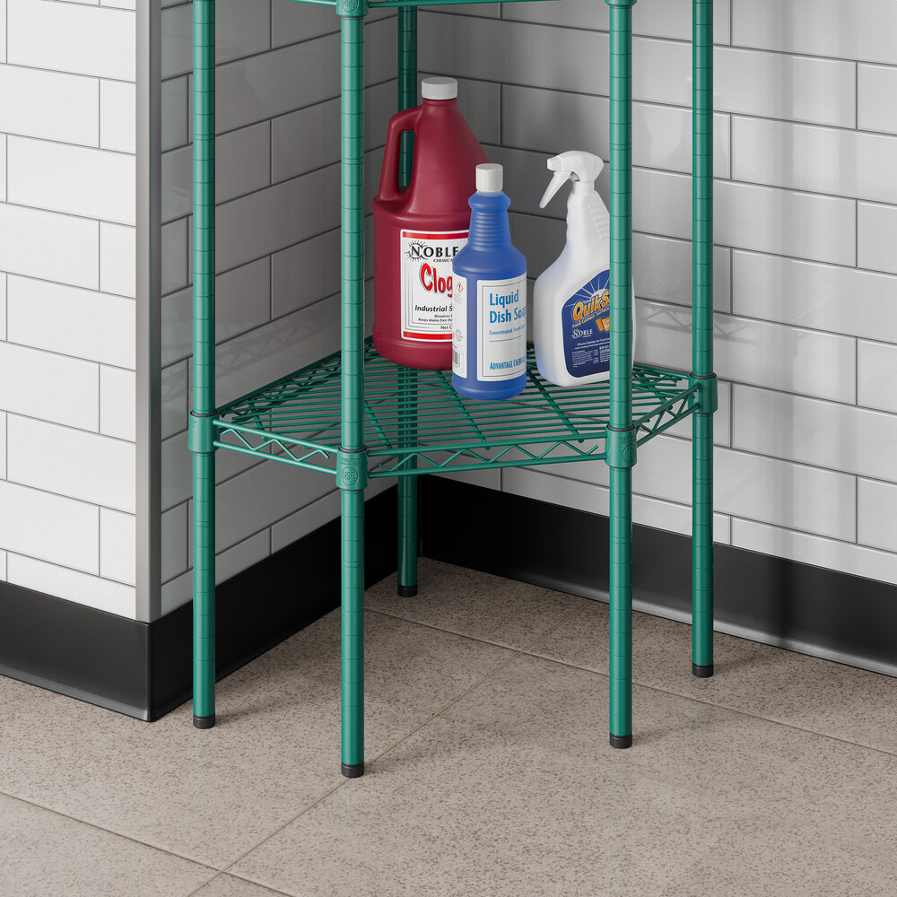 A green epoxy wire pentagon corner shelf placed in a tiled room corner holding cleaning supplies.