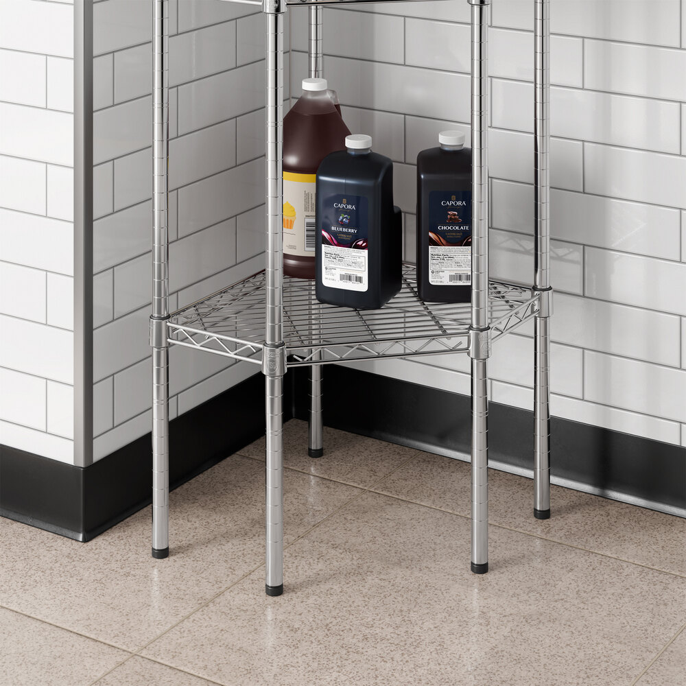 A chrome wire pentagon corner shelf designed for storage in kitchens or commercial spaces.