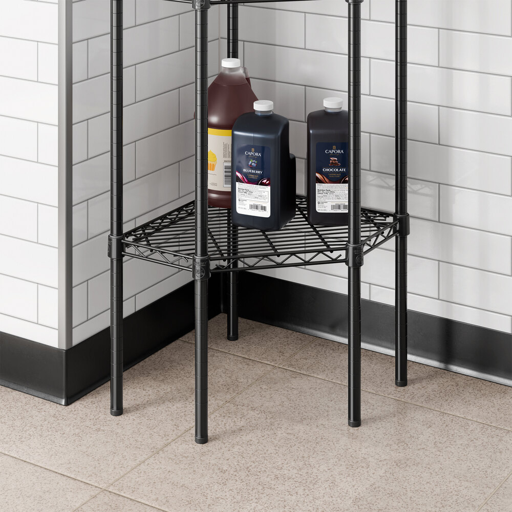 A black epoxy wire pentagon corner shelf designed for storage in commercial or residential spaces.