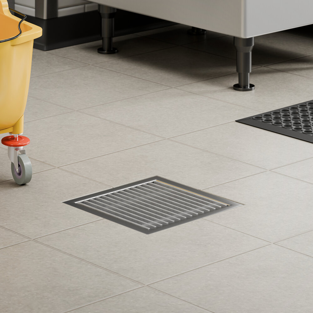 A stainless steel grate designed for 12 inch by 12 inch floor drains.
