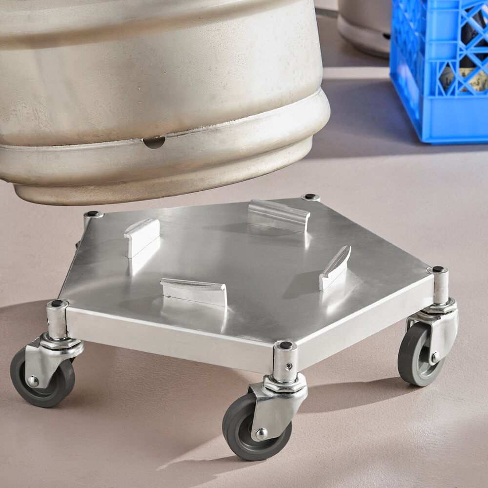 A metal hexagonal dolly with four swivel casters and raised brackets on top, designed for transporting heavy cylindrical containers.