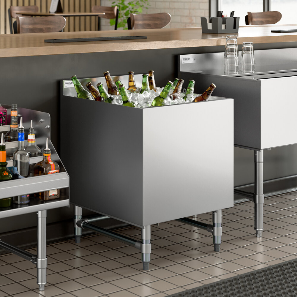 A stainless steel beer box filled with ice and bottled beverages, designed for bar use.