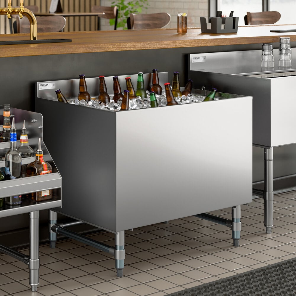 A stainless steel beer box with a backsplash, filled with ice and bottled beverages, designed for bar use.