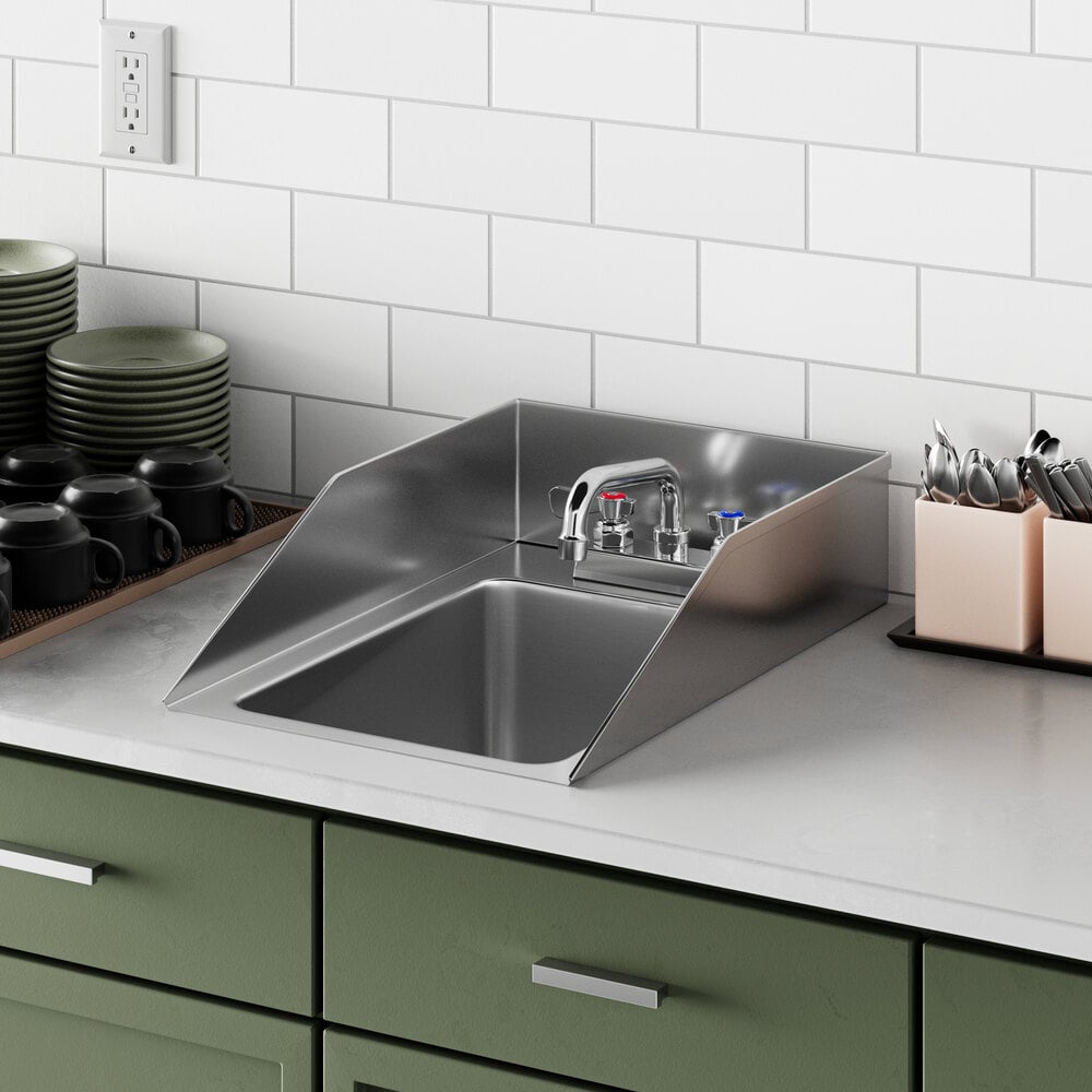 A Regency stainless steel drop-in sink with side splashes on a counter.