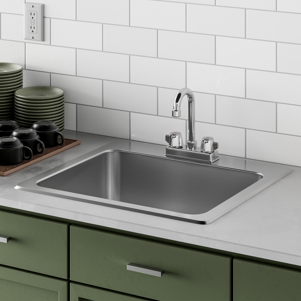 A Regency drop-in sink with a gooseneck faucet and a tray of dishes on the counter.