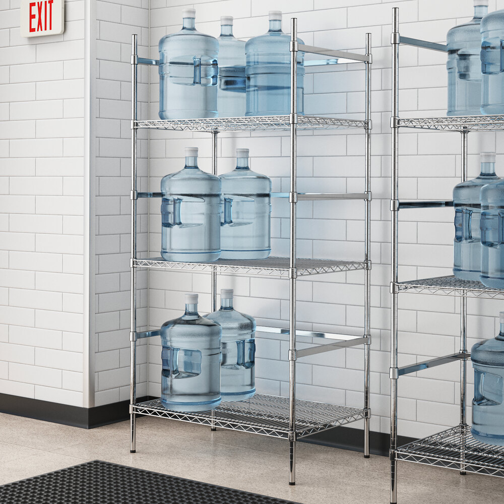 A metal wire rack with three shelves holding Regency water jugs.