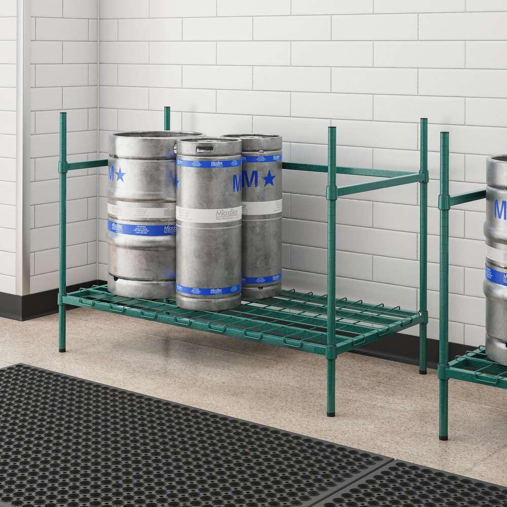 A Regency metal rack with three green epoxy kegs on it.