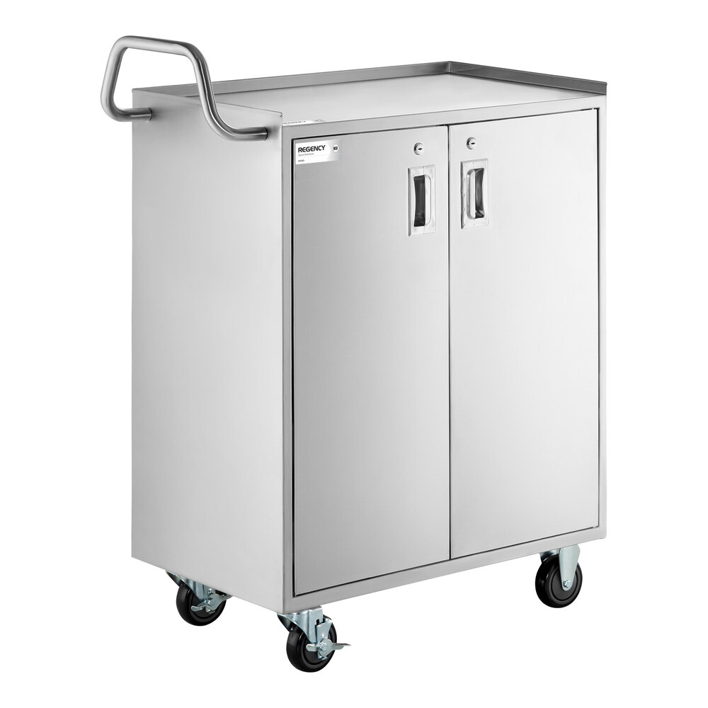 A stainless steel utility cart with an enclosed base, two locking doors, a handle, and four caster wheels.