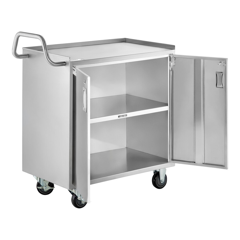 A stainless steel utility cart with three shelves, an enclosed base, locking doors, a side handle, and four caster wheels.