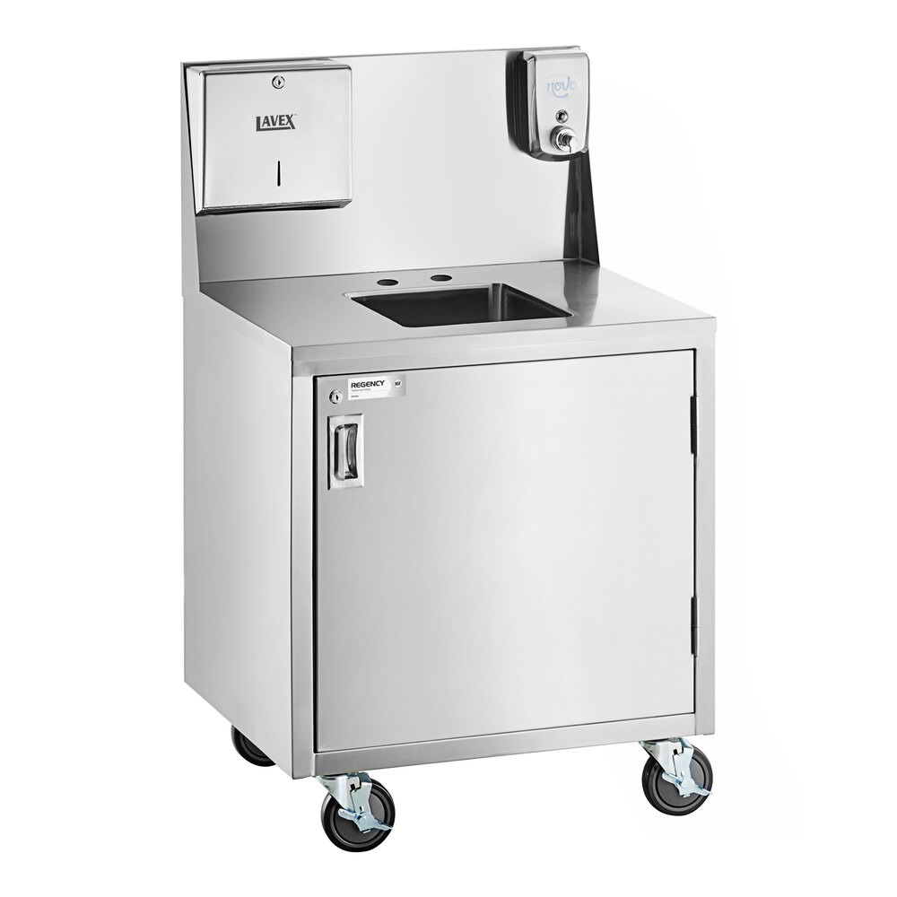 A stainless steel portable hand sink cart with a single bowl, cabinet, paper towel dispenser, soap dispenser, and four caster wheels.