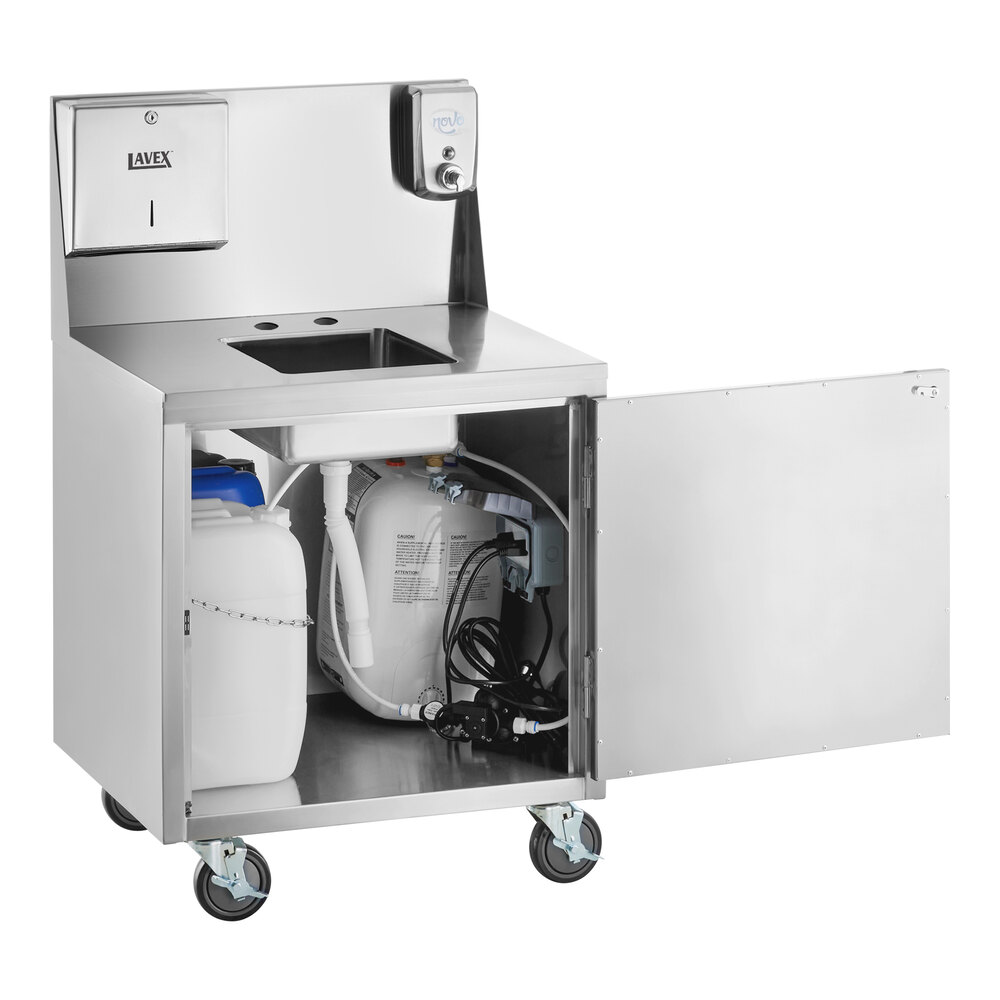 A stainless steel portable hand sink cart with a single bowl, paper towel dispenser, soap dispenser, and an open cabinet door revealing water containers and plumbing inside.