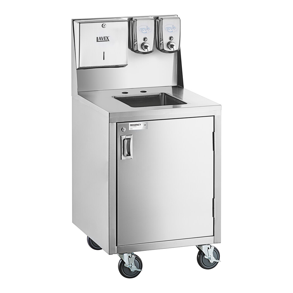 A stainless steel portable hand sink cart with a single bowl, cabinet, paper towel dispenser, and two soap dispensers, mounted on four caster wheels.