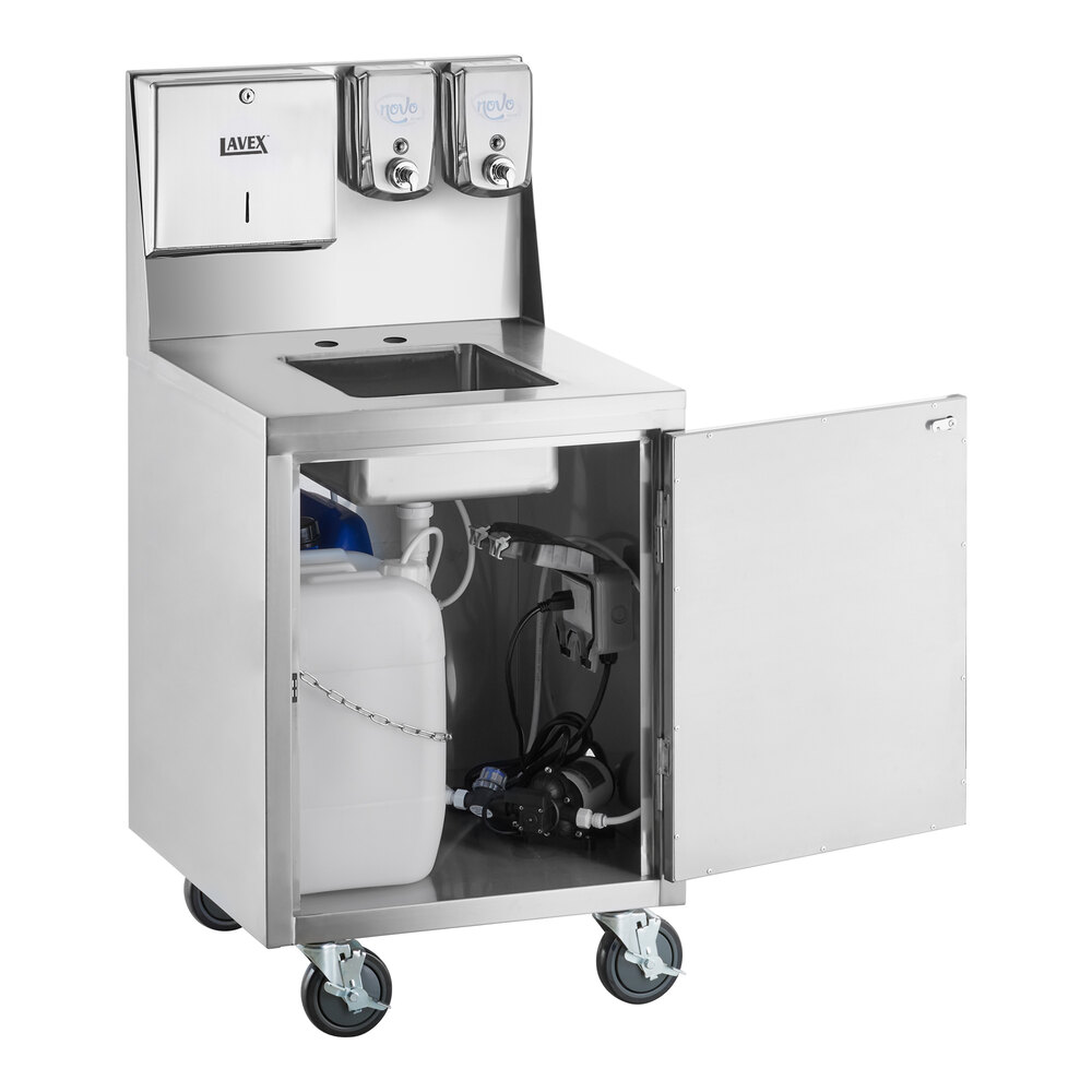 A stainless steel portable hand sink cart with a single bowl, paper towel and soap dispensers, and an open cabinet door revealing water containers and plumbing inside.