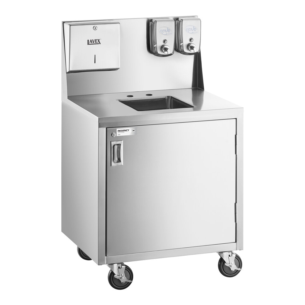 A stainless steel portable hand sink cart with a single bowl, cabinet door, paper towel dispenser, two soap dispensers, and four caster wheels.