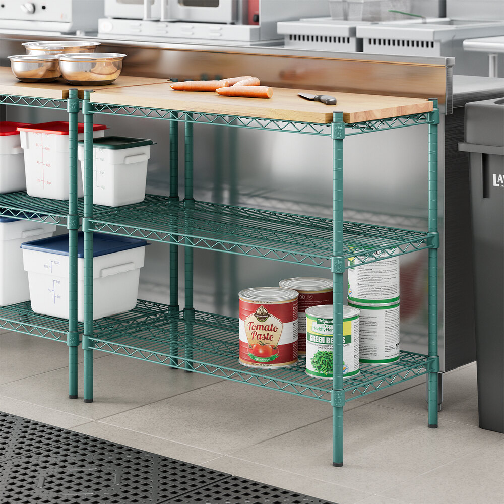 Regency green metal shelving with wooden shelves holding food containers.