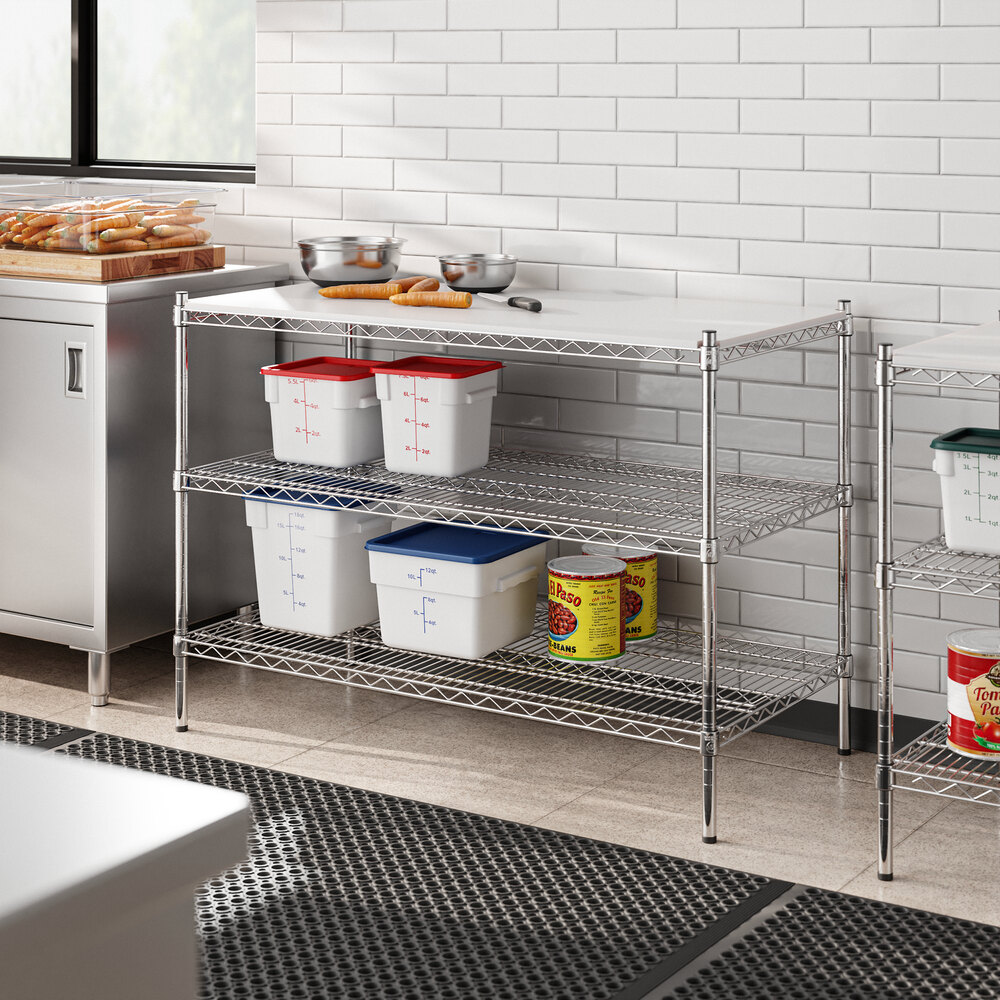 A kitchen with a white counter and Regency chrome shelves.