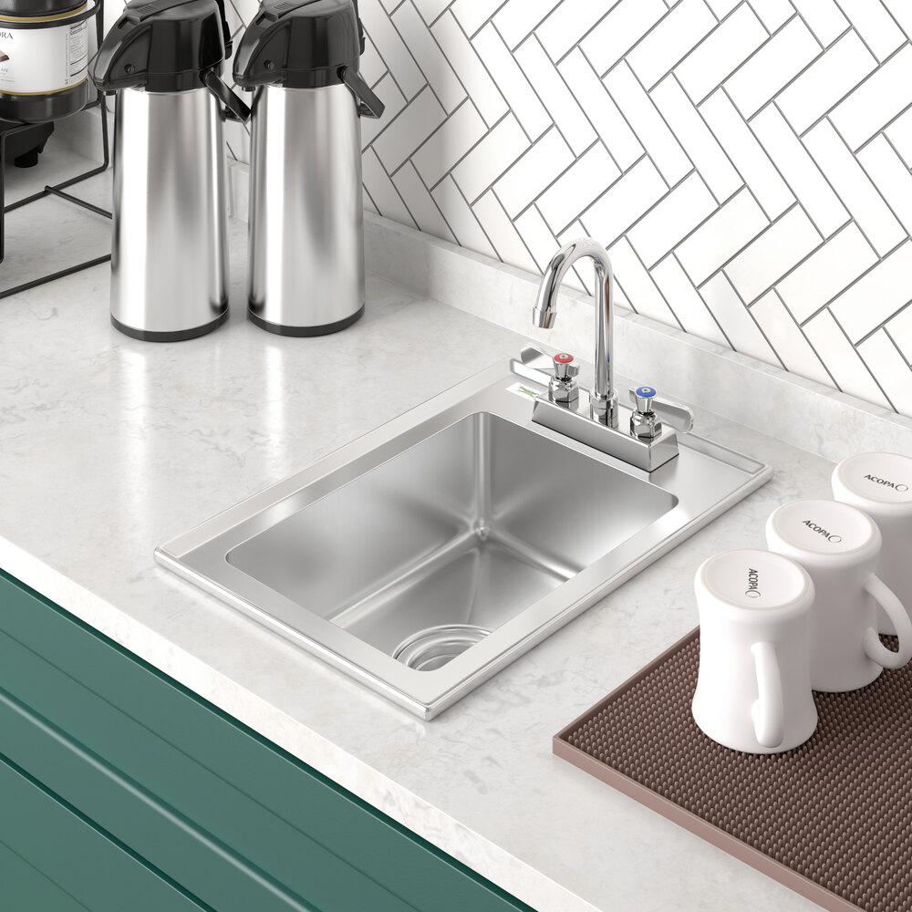 A Regency stainless steel drop-in sink in a kitchen counter with a white coffee mug.