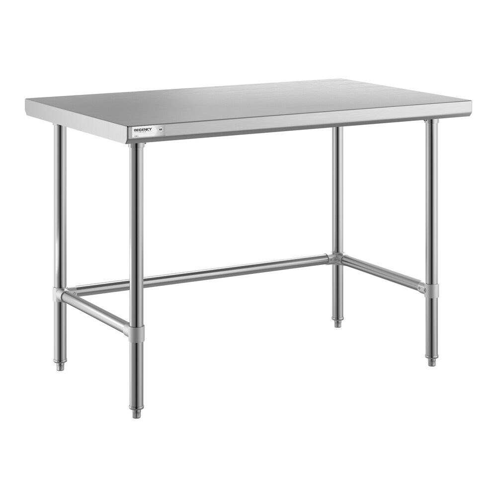 A stainless steel table with an open base and four legs connected by horizontal support bars.