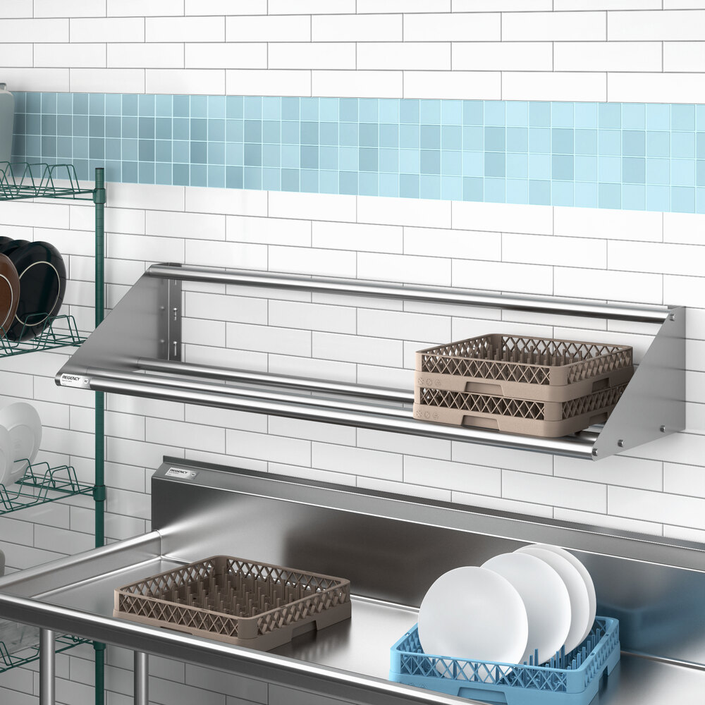 A stainless steel wall-mounted tubular rack shelf used for storage in a commercial kitchen.