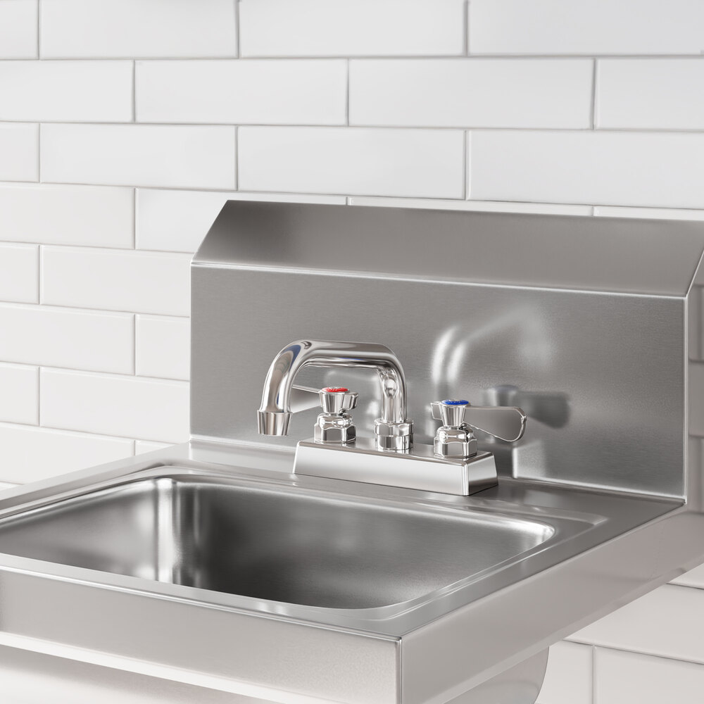 A stainless steel deck-mounted faucet with 4-inch centers and a 6-inch swing spout installed on a commercial sink.