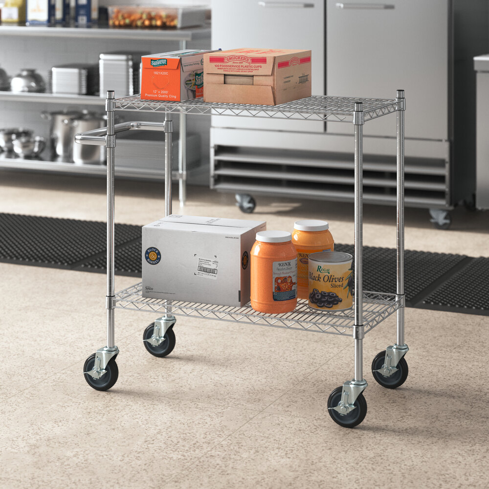 A chrome Regency utility cart with food containers on it.