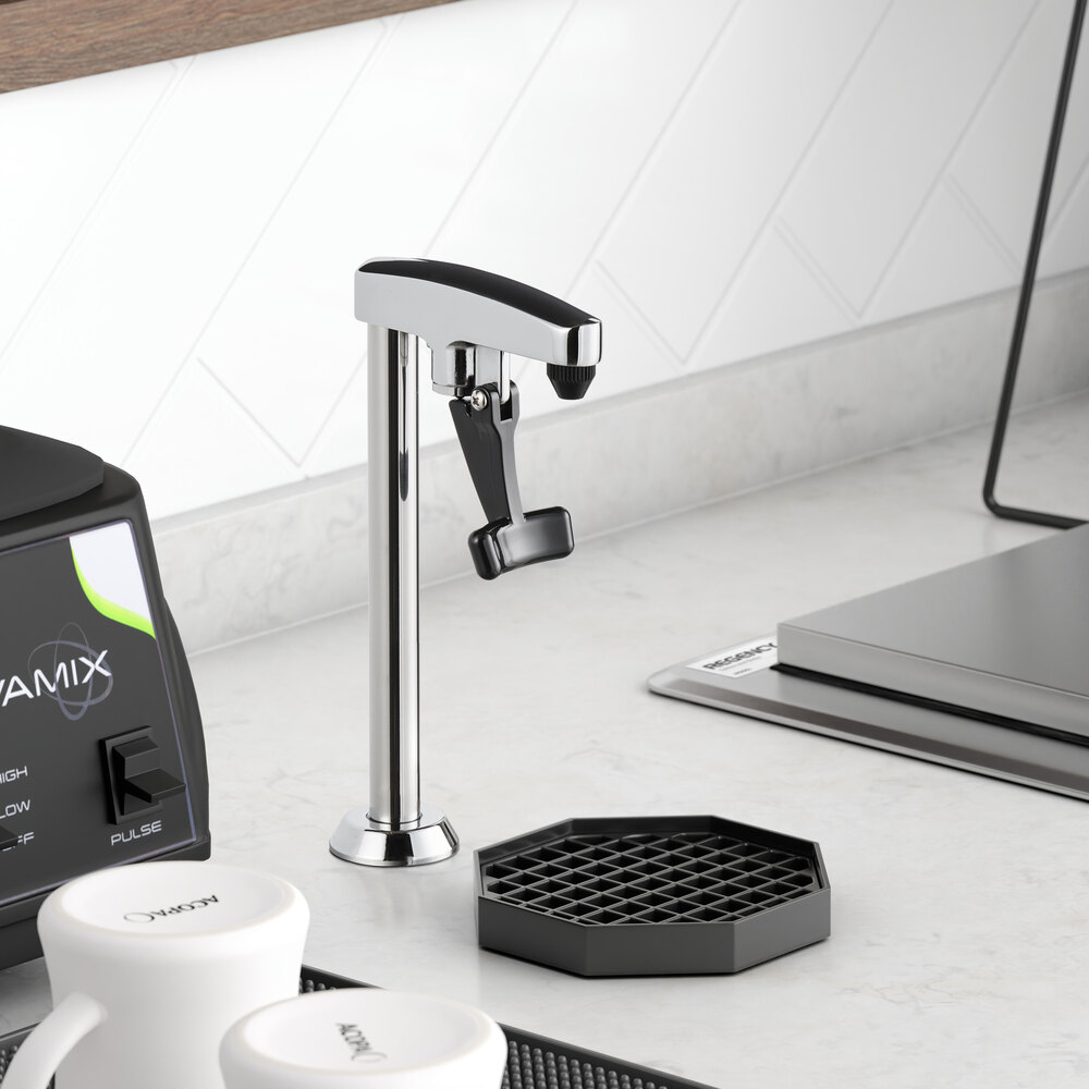 A metal countertop glass filler with a lever handle is installed on a kitchen counter next to a black drip tray.