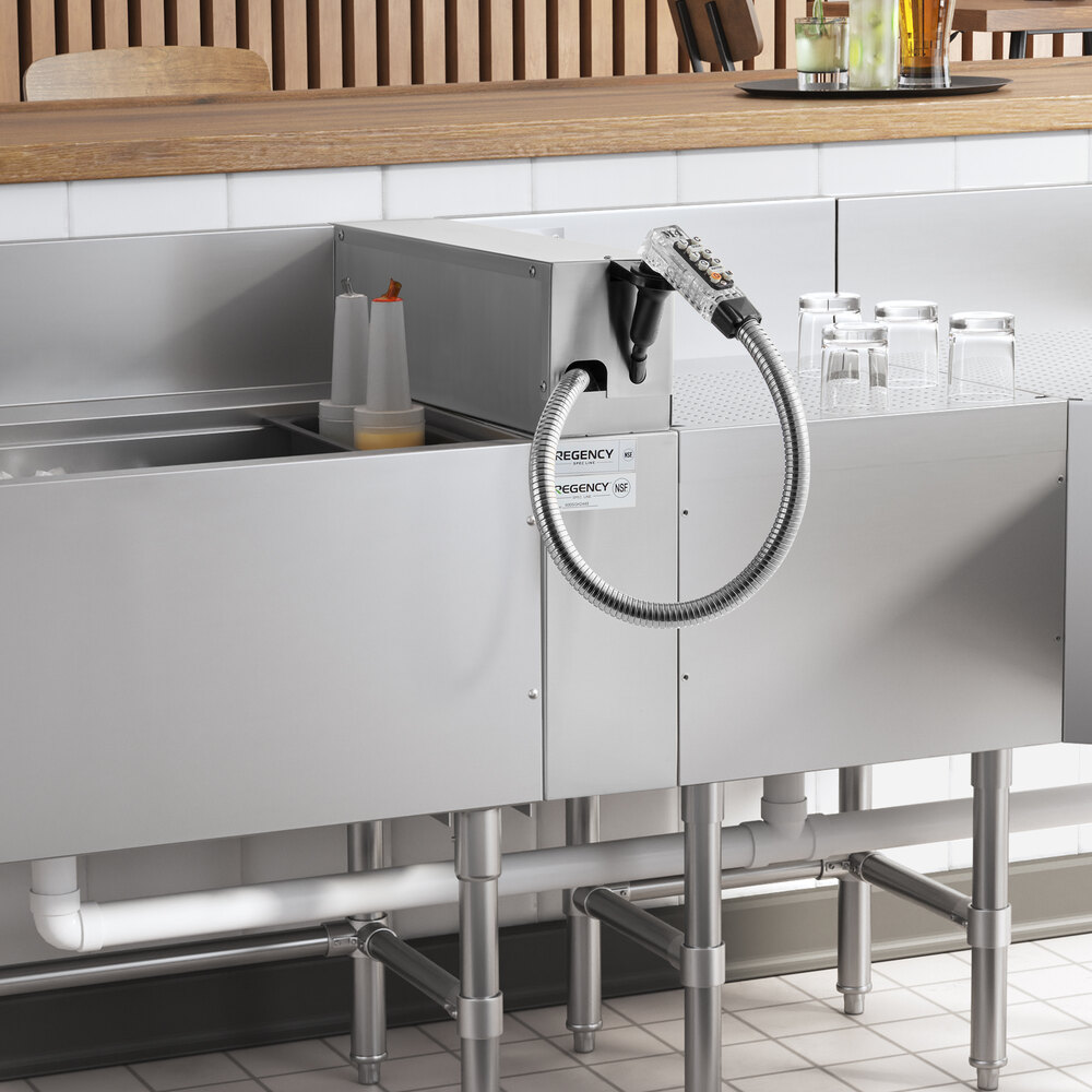 A Regency stainless steel soda gun holder machine on a counter with a drink dispenser.