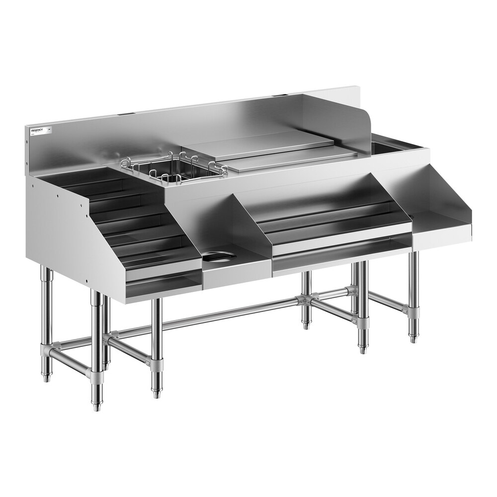 A stainless steel commercial cocktail station with multiple compartments, a liquor display rack, and a cold plate, supported by sturdy metal legs.