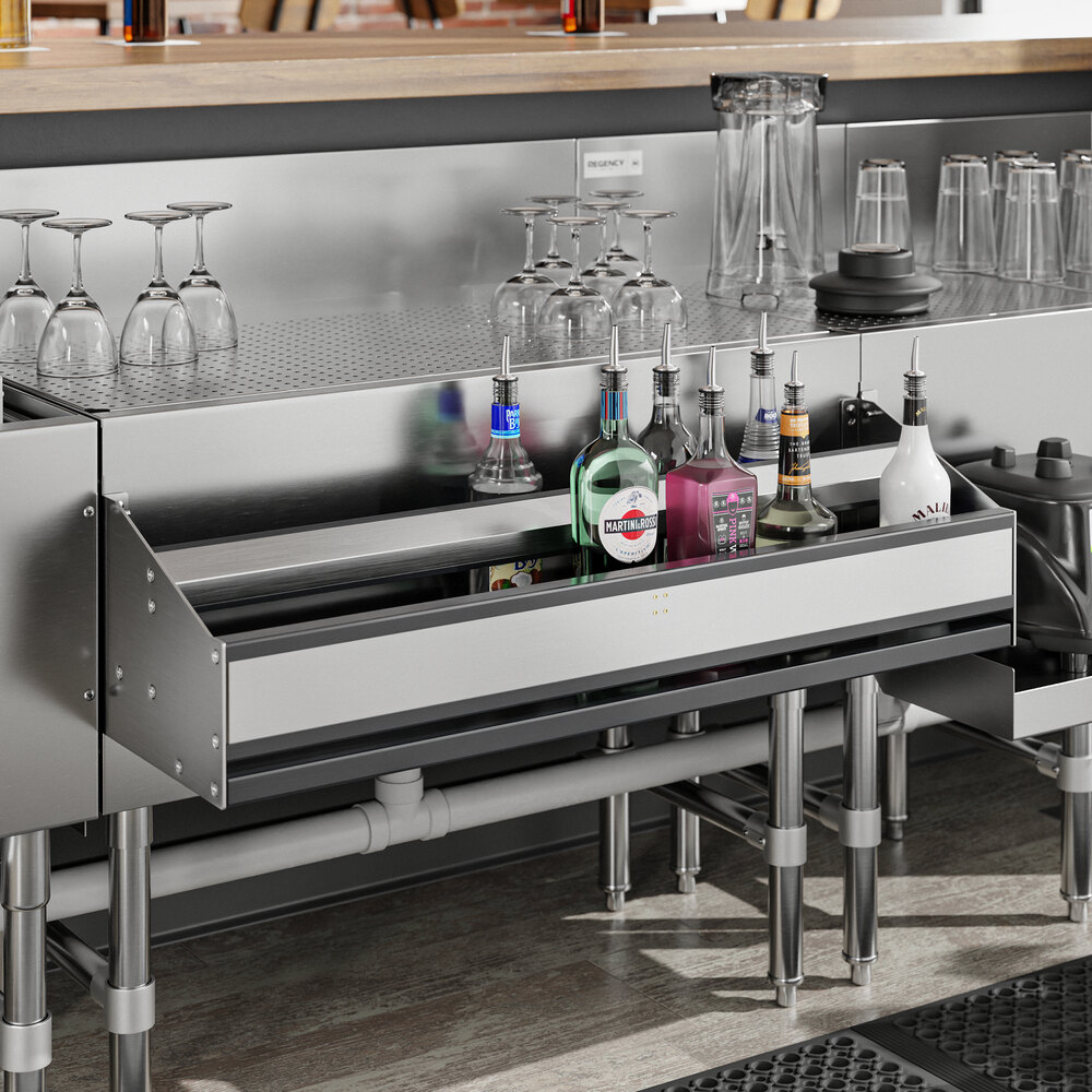 A Regency stainless steel double tier speed rail holding bottles on a counter.