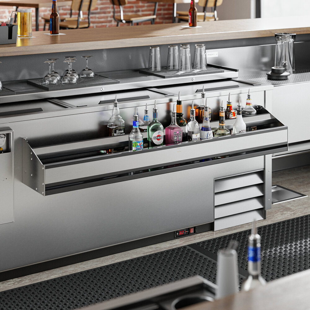 A Regency double tier speed rail holding bottles and glasses on a bar counter.