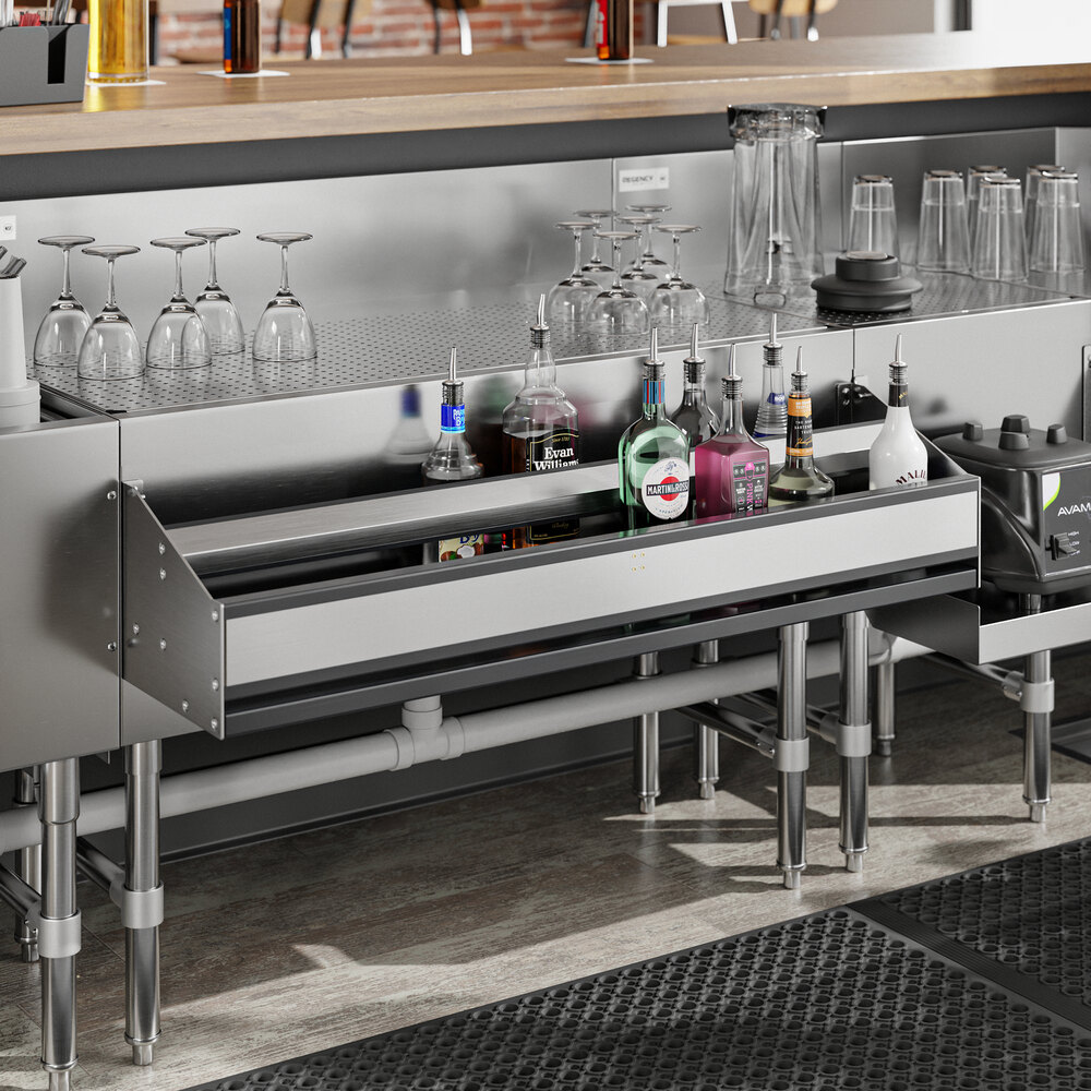 A stainless steel Regency double tier speed rail holding bottles on a counter in a cocktail bar.