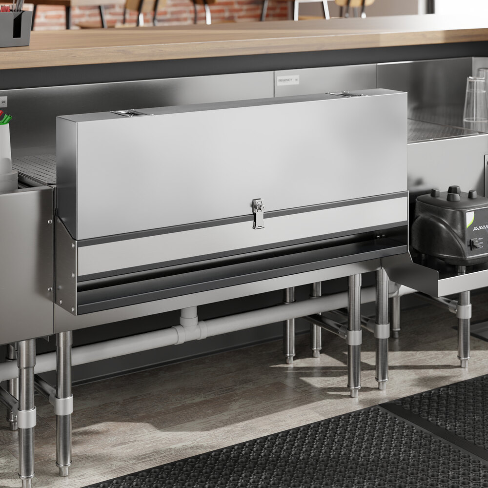 A stainless steel cover with a metal handle on a kitchen counter.