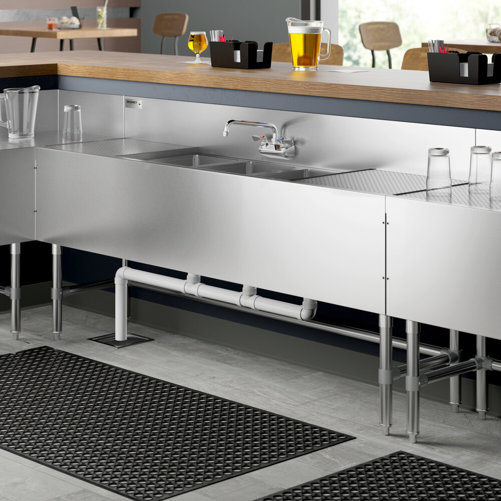 A Regency stainless steel underbar sink with (2) 18" drainboards on a counter.