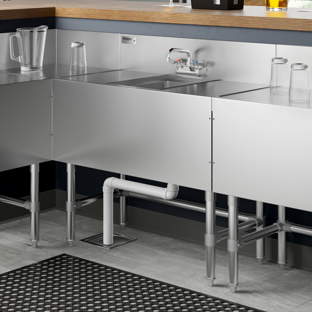 A Regency stainless steel underbar sink with (2) 12" drainboards and a faucet.
